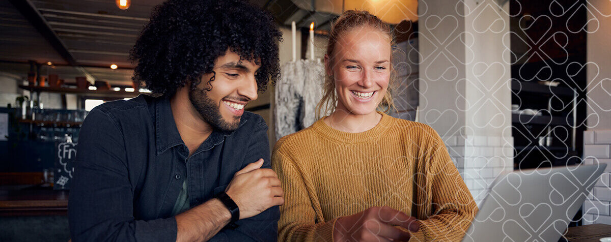 Two people using a laptop